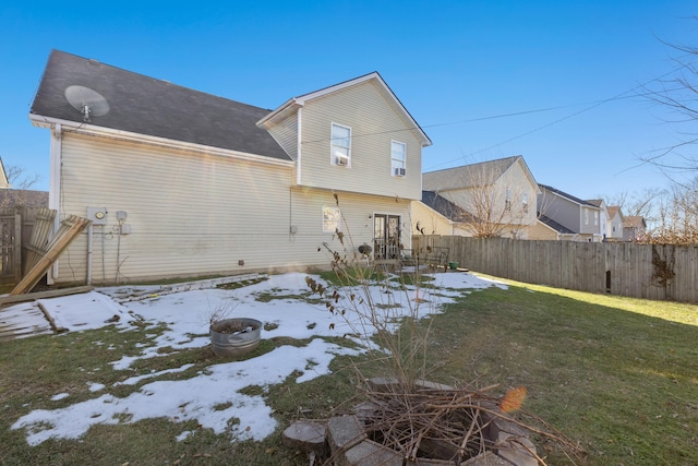 rear view of house featuring a lawn