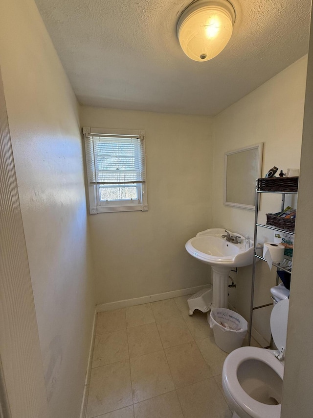 bathroom featuring toilet and a textured ceiling