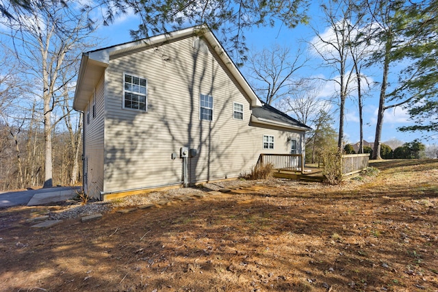 view of side of home with a deck