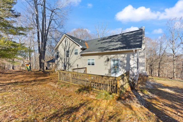 rear view of property with a wooden deck