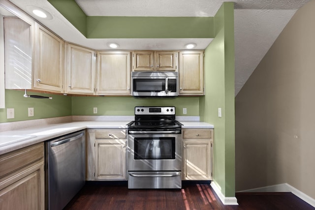 kitchen featuring appliances with stainless steel finishes, dark hardwood / wood-style flooring, a textured ceiling, and light brown cabinets