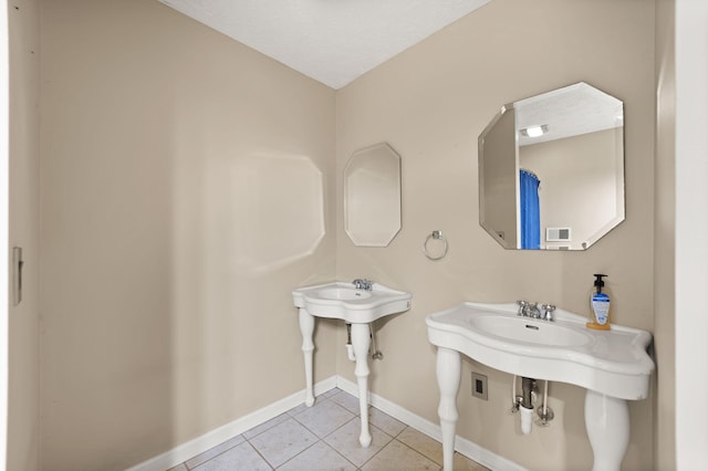 bathroom featuring tile patterned flooring and double sink