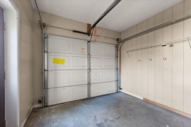 garage featuring wood walls