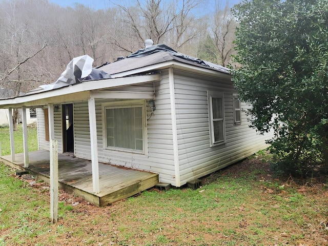 view of side of property with a lawn