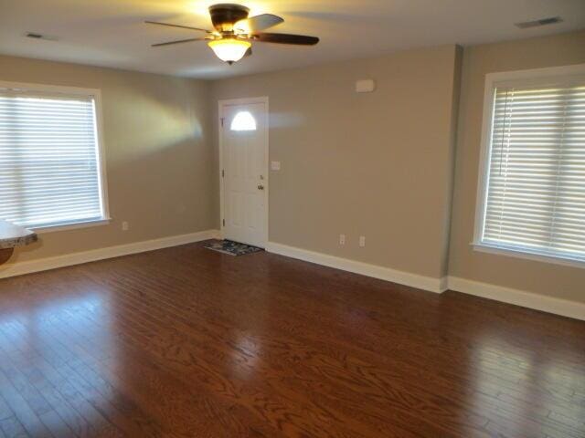 interior space with ceiling fan and dark hardwood / wood-style floors