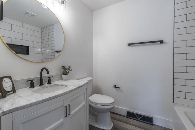 bathroom featuring vanity, hardwood / wood-style floors, and toilet