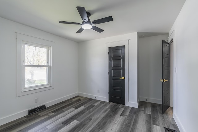 unfurnished bedroom featuring dark hardwood / wood-style floors and ceiling fan