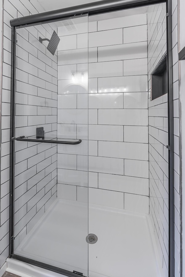 bathroom with a shower with door