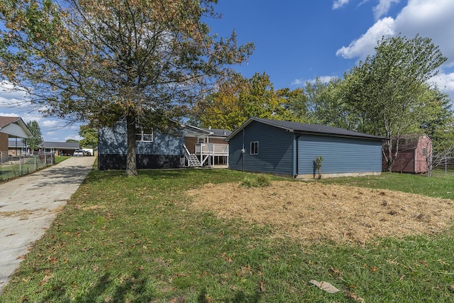 view of yard with a storage shed and a wooden deck