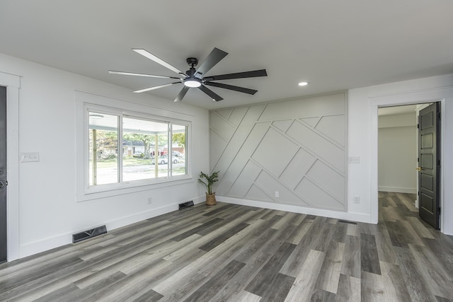 unfurnished room featuring ceiling fan and dark hardwood / wood-style flooring