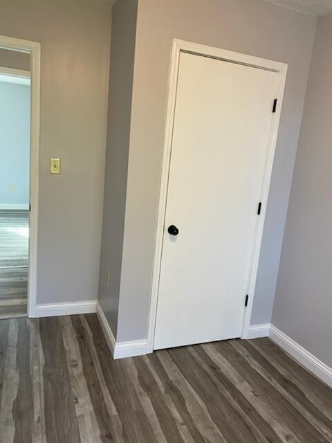 interior space featuring baseboards and wood finished floors