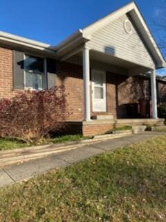 exterior space with a porch and a front lawn