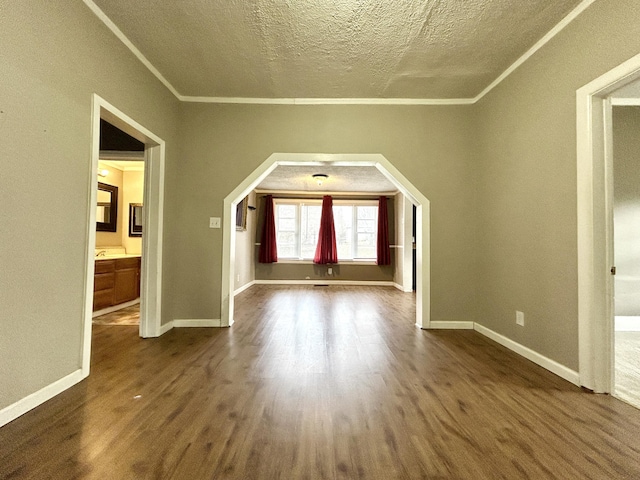 bonus room with dark wood-type flooring and a textured ceiling