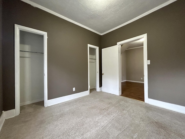 unfurnished bedroom featuring crown molding, light carpet, and a textured ceiling