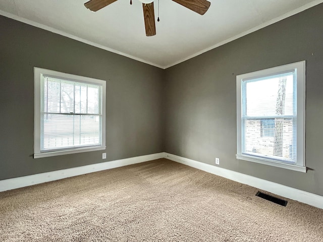 carpeted empty room featuring ornamental molding and ceiling fan