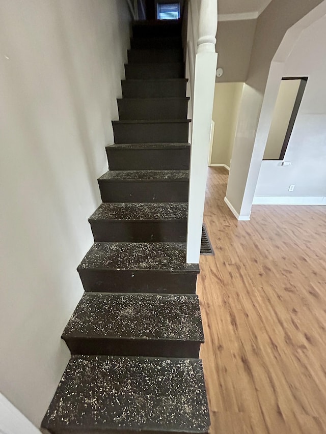 stairs with hardwood / wood-style flooring