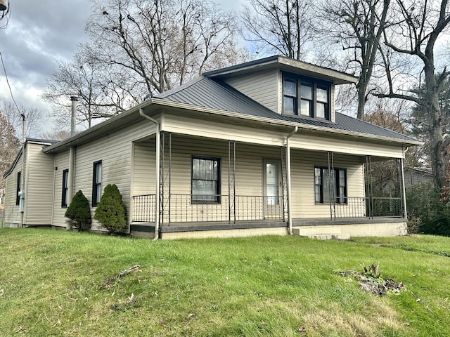 bungalow-style house with a front yard and covered porch