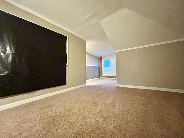 bonus room with vaulted ceiling and carpet