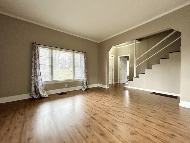 unfurnished living room with hardwood / wood-style flooring and ornamental molding