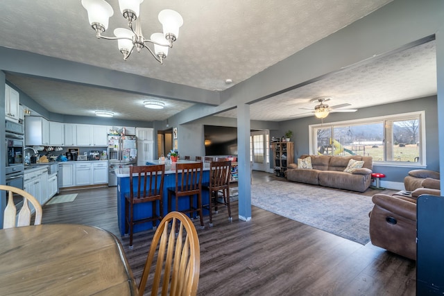 dining area featuring a wealth of natural light, dark hardwood / wood-style floors, and a textured ceiling