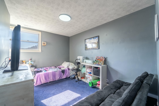 bedroom with carpet flooring and a textured ceiling