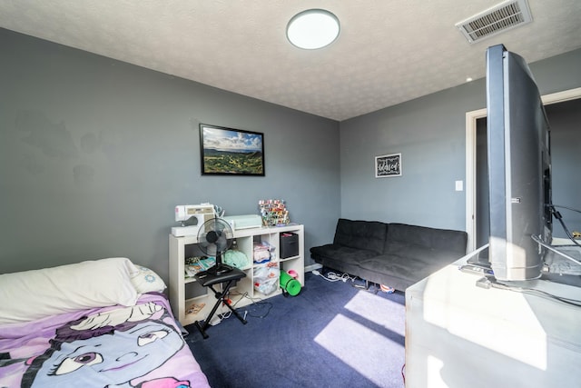 bedroom with a textured ceiling and carpet flooring