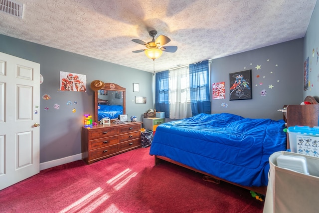 carpeted bedroom featuring ceiling fan and a textured ceiling