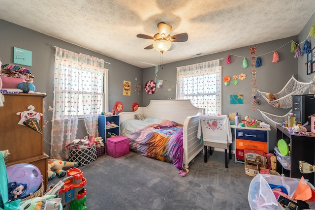 carpeted bedroom featuring a textured ceiling and ceiling fan