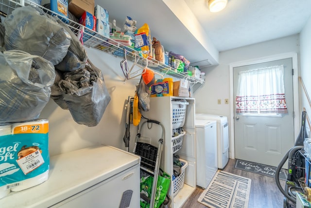 laundry room with separate washer and dryer and hardwood / wood-style floors