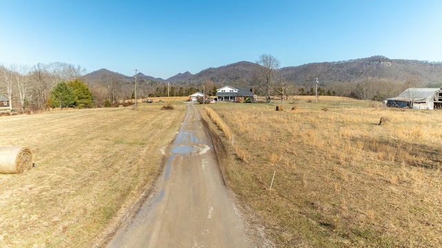 view of street with a mountain view and a rural view