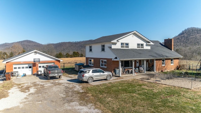 view of front property with a mountain view and covered porch