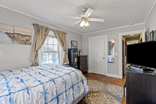 bedroom featuring crown molding, wood-type flooring, and ceiling fan