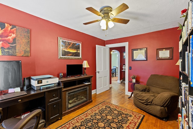 office with ceiling fan and light hardwood / wood-style floors