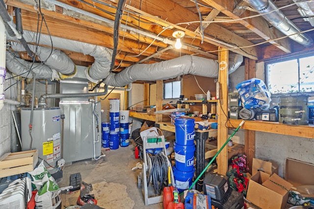 basement featuring water heater and plenty of natural light