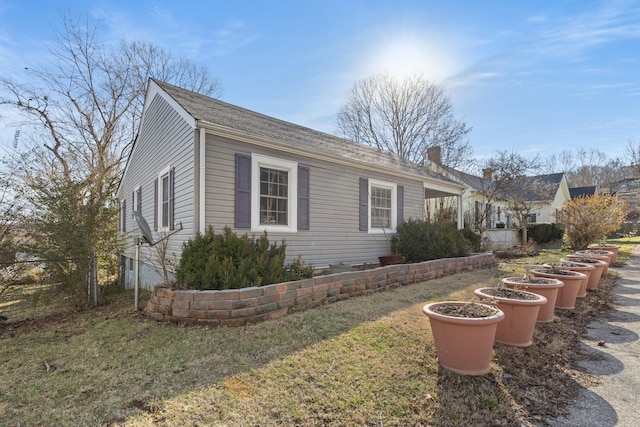 view of side of home with a lawn