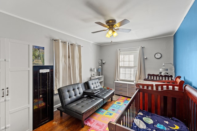 bedroom with wood-type flooring, ornamental molding, and ceiling fan