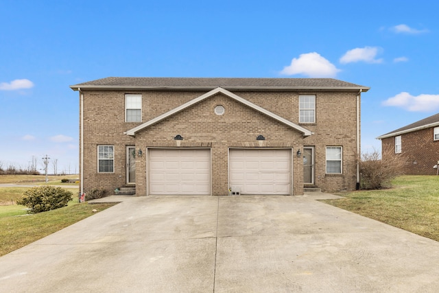 view of property featuring a garage and a front yard