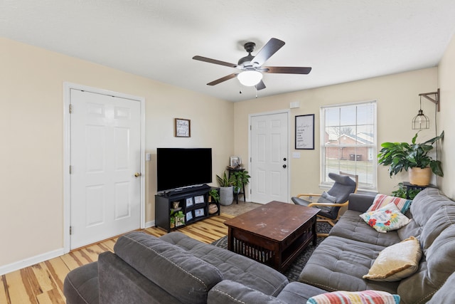 living room with wood-type flooring and ceiling fan