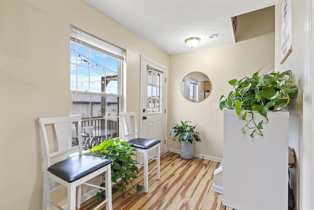 entryway featuring a textured ceiling and light wood-type flooring