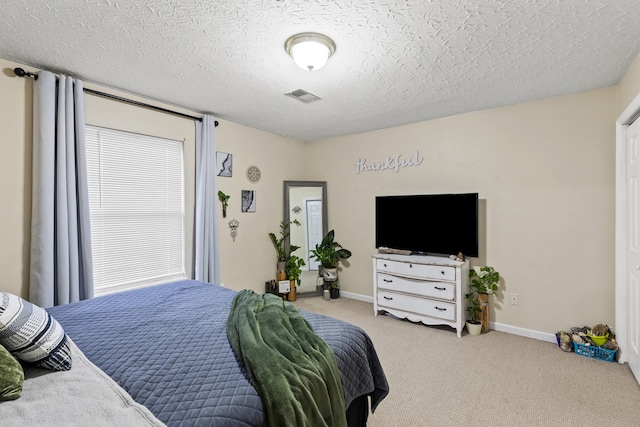 carpeted bedroom with a textured ceiling