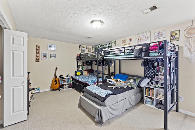 bedroom featuring carpet and a textured ceiling