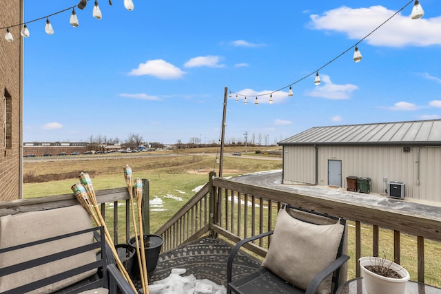 deck with central AC unit and a rural view