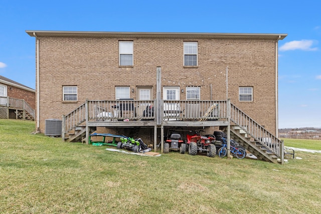 back of house with a wooden deck, cooling unit, and a lawn