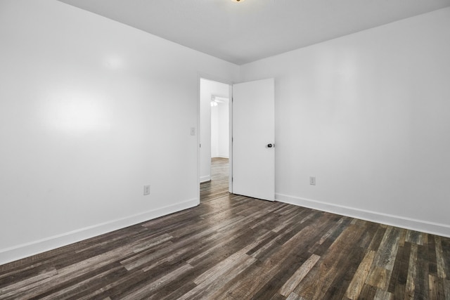 empty room with dark wood-type flooring