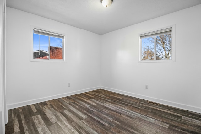 unfurnished room with dark hardwood / wood-style floors