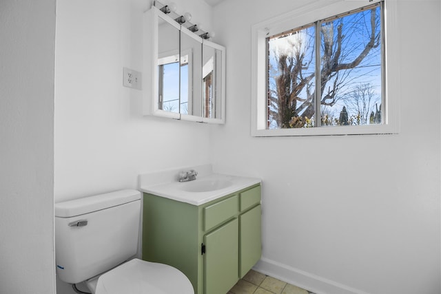 bathroom featuring vanity, tile patterned floors, and toilet