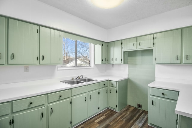 kitchen with green cabinetry, dark hardwood / wood-style floors, and sink