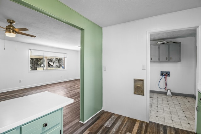 laundry room with ceiling fan, dark wood-type flooring, and a textured ceiling