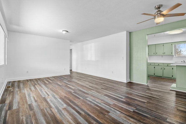 spare room featuring ceiling fan and dark hardwood / wood-style flooring