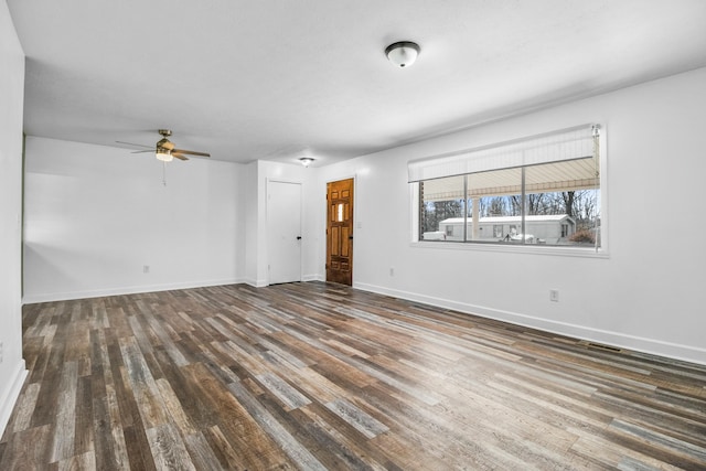 unfurnished living room with ceiling fan and dark hardwood / wood-style floors